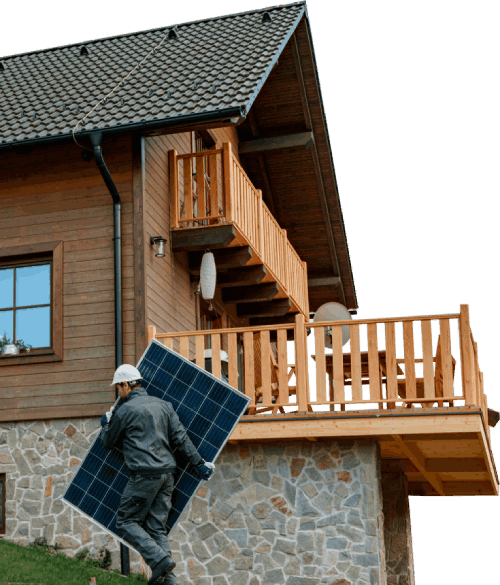 Man carrying a solar panel in front of a house