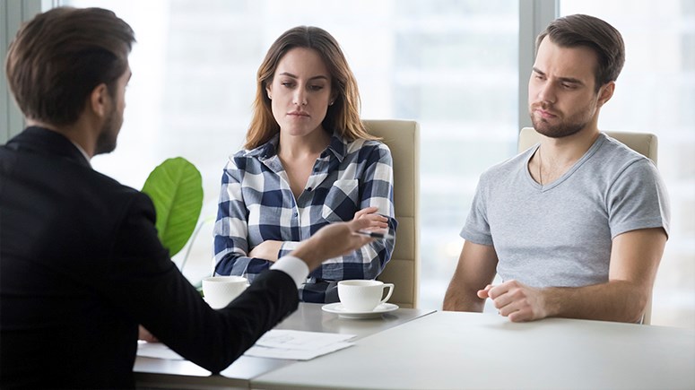 Male and Female upset while a consultant speaks with them