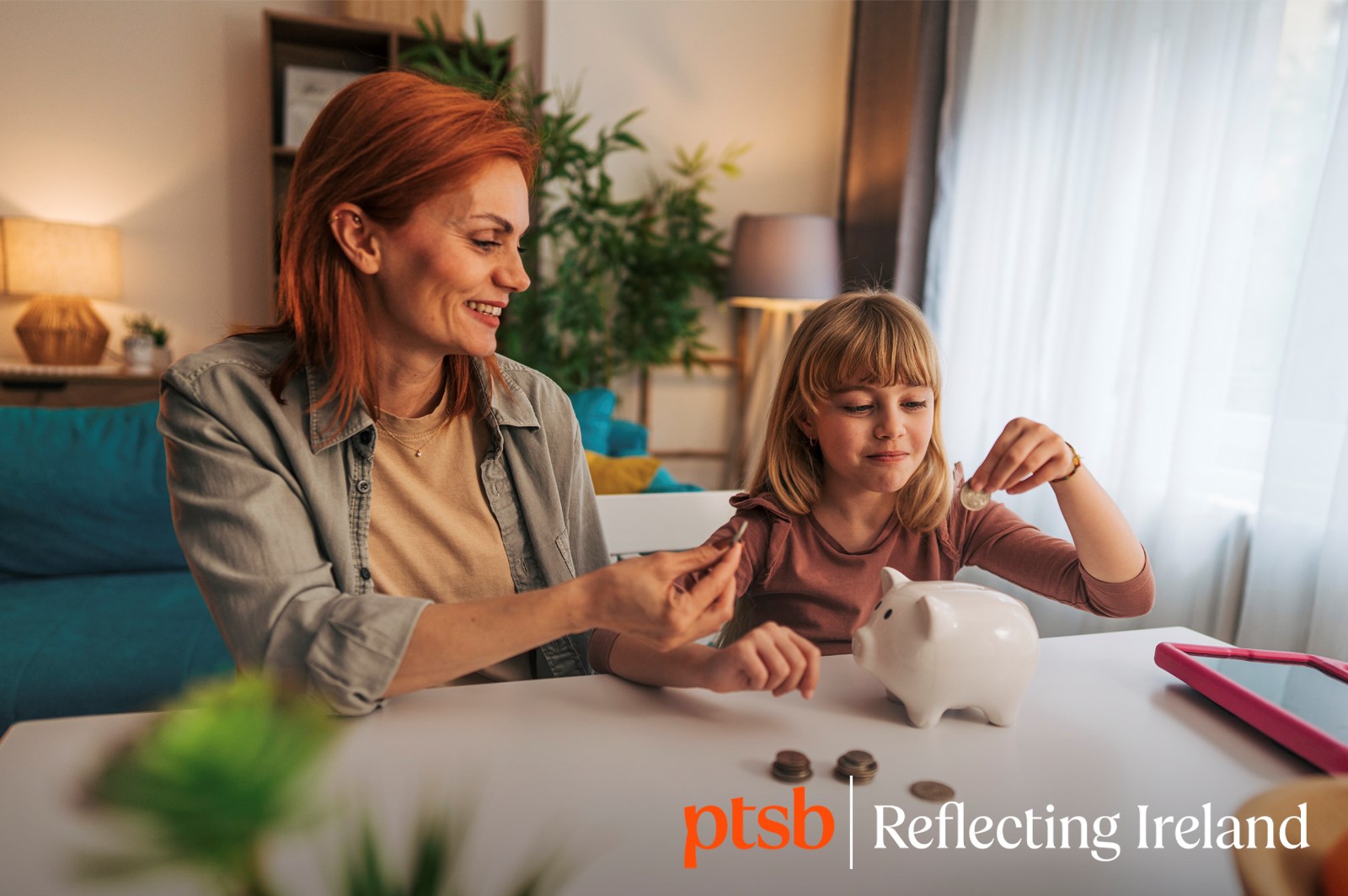 a woman and a young girl learning about finances, sitting in a living room