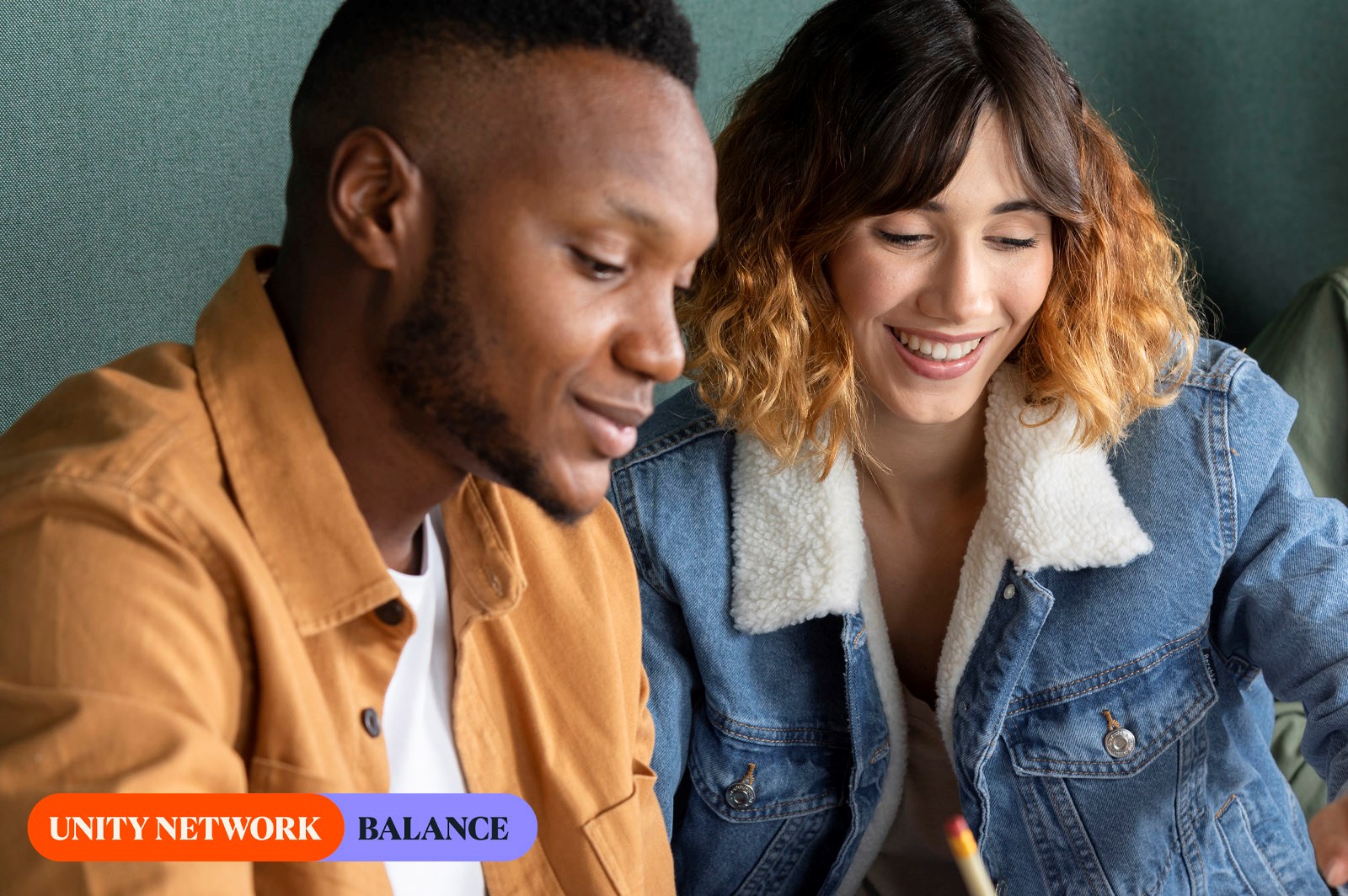 young couple looking at something together and smiling 