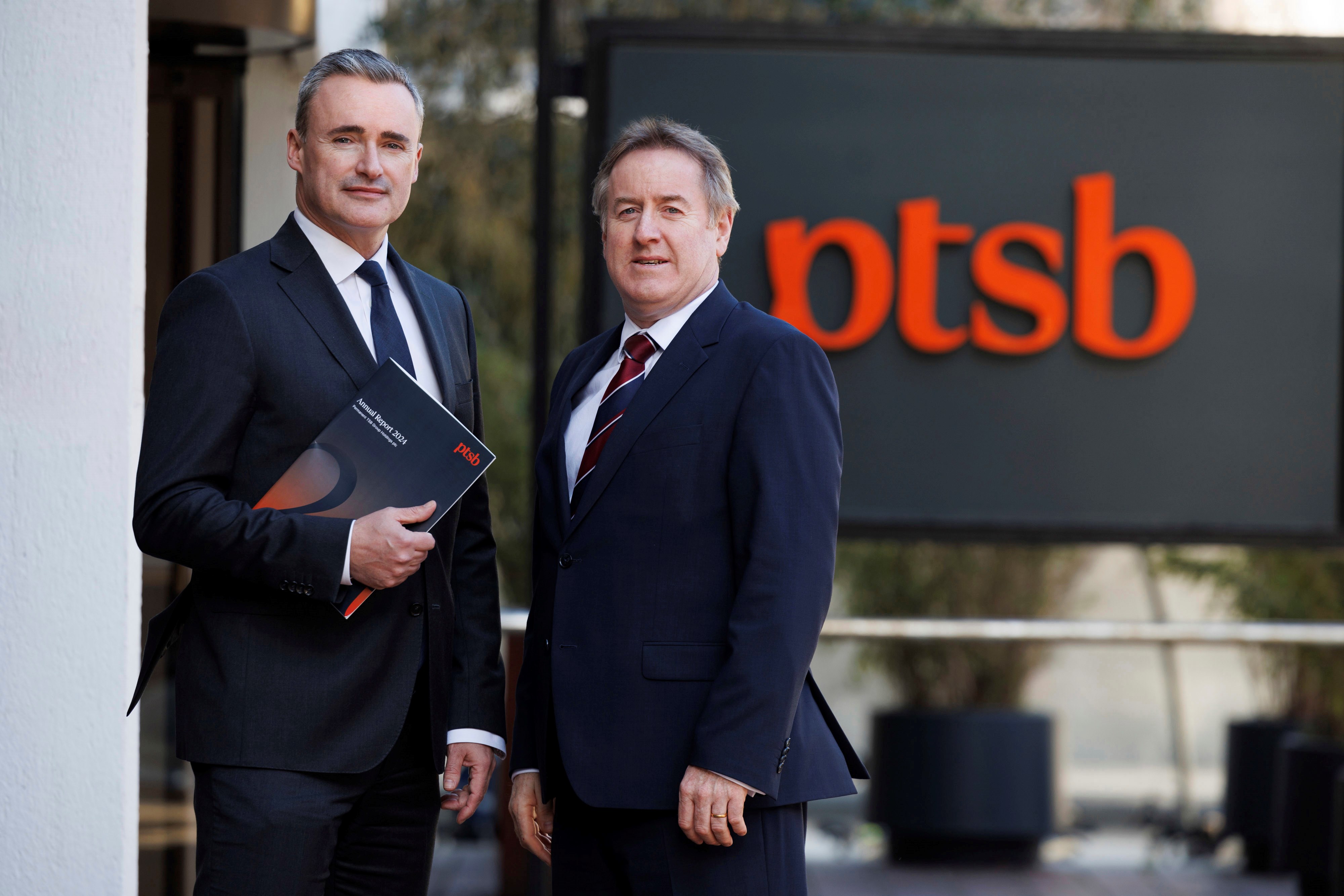 PSB CEO Eamonn Crowley and CFO Barry D'Arcy with PTSB logo in background 