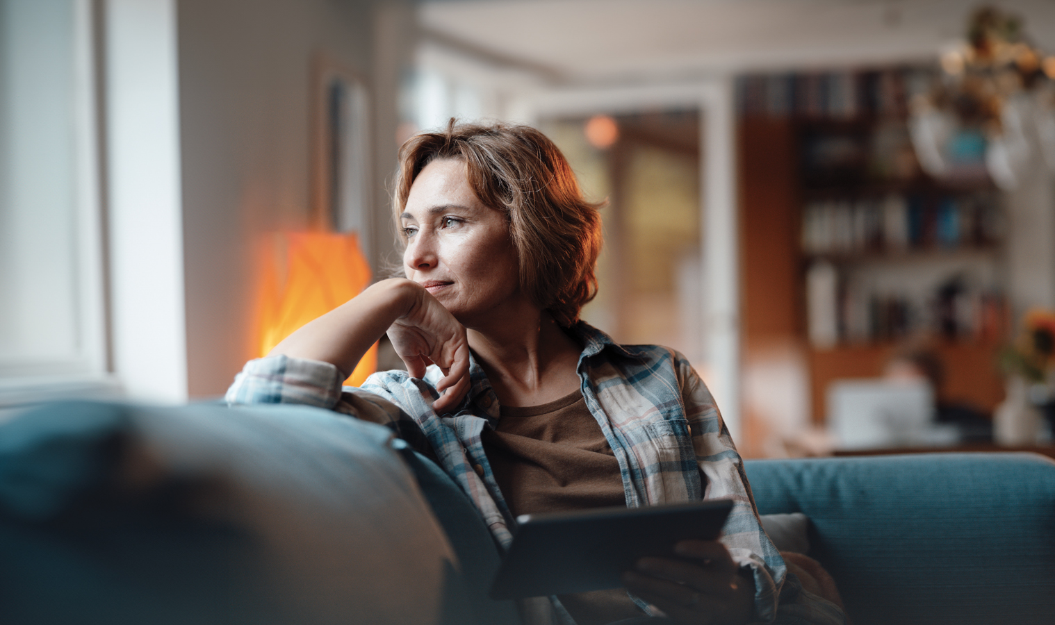 A women in deep thought while sitting on the sofa