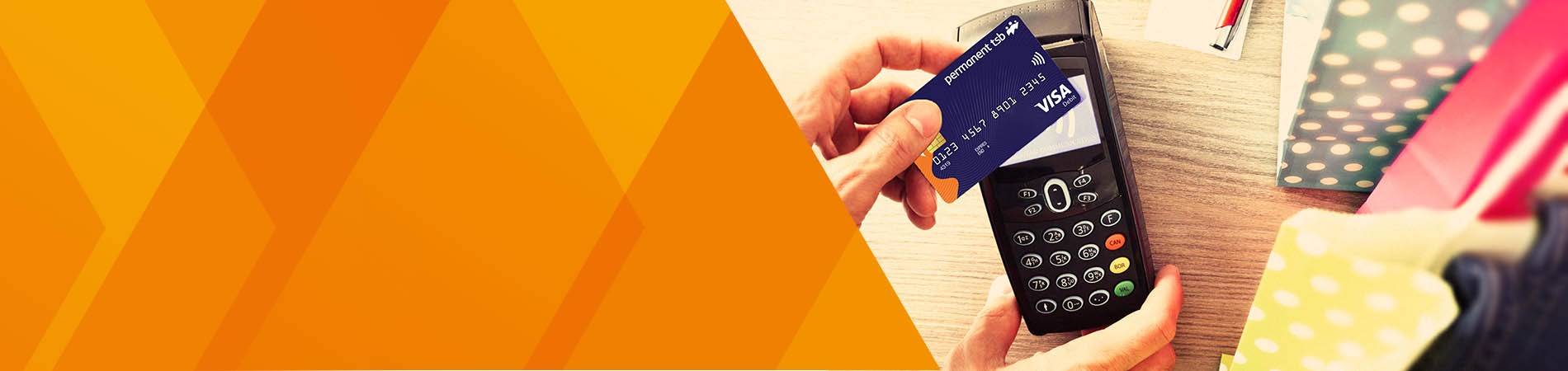 close up on Permanent tsb Visa Debit Card being held up to a Credit Card machine in a shop