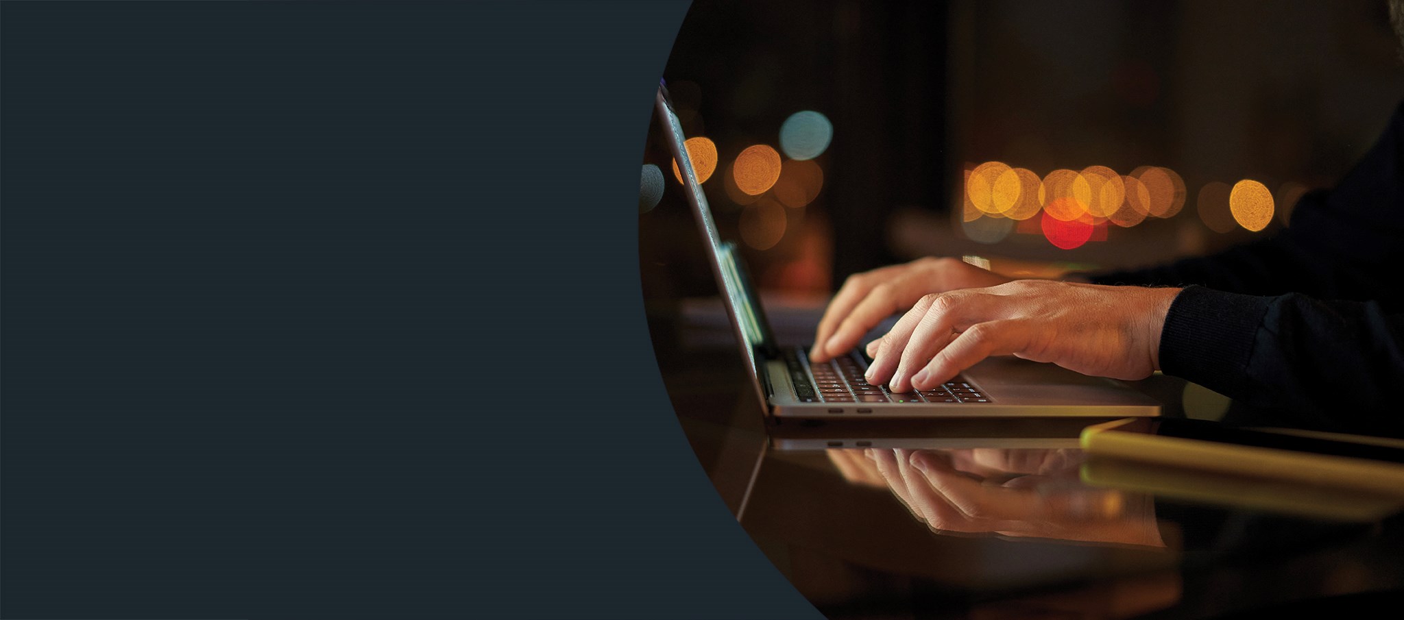 close up on man's hands working on a laptop