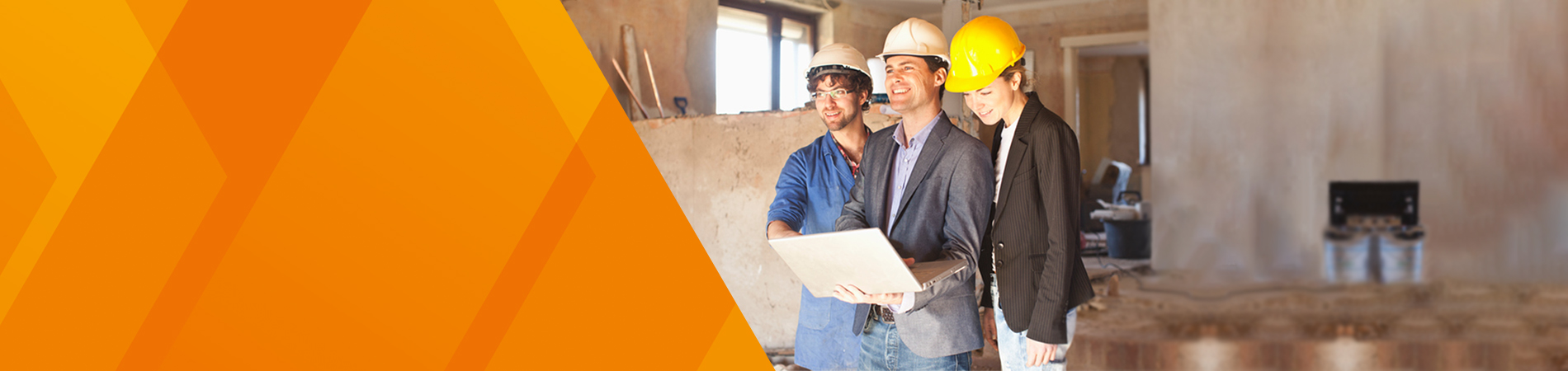 3 people on building site with safety helmets smilling while looking at laptop