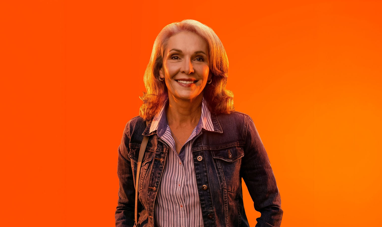 lady with smile on her face, standing on an orange background